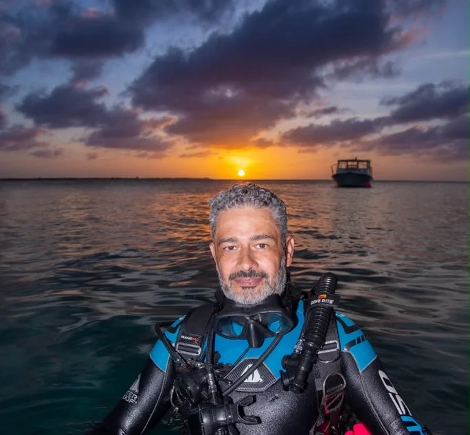 Ricardo Castillo in diving equipment at sunset in Bonaire